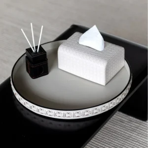 Round Black Leather Entryway Tray with Studded Rim in black — in a room setting