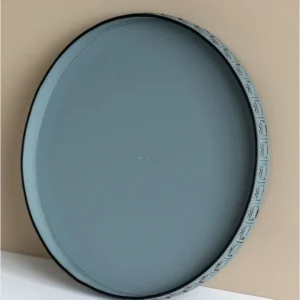 Round Black Leather Entryway Tray with Studded Rim in black — in a room setting
