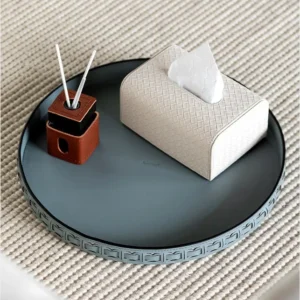 Round Black Leather Entryway Tray with Studded Rim in black — in a room setting