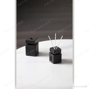 Leather-Wrapped Reed Diffuser Bottle in Tan — in a room setting