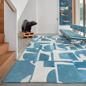 Blue and Cream Abstract Collage Rug in blue — in a room setting