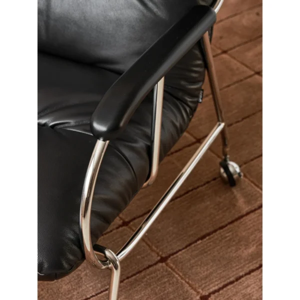 S-Curve Black Leather Lounge Chair in black — in a room setting