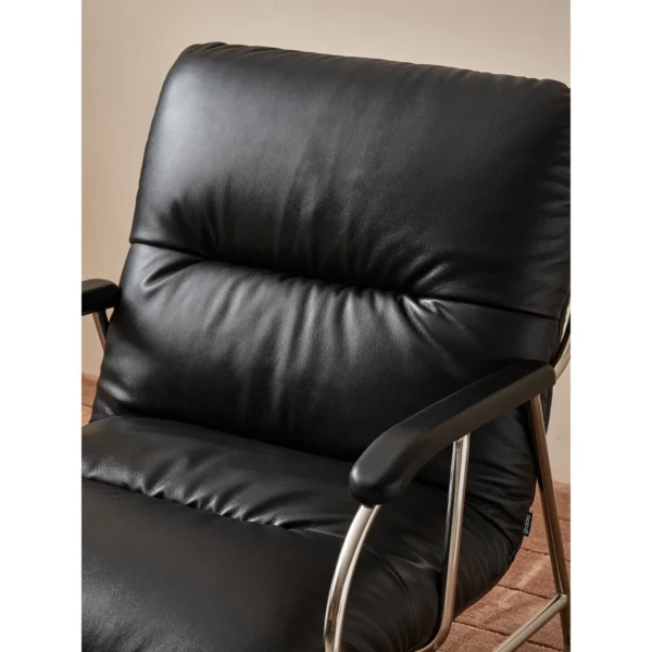 S-Curve Black Leather Lounge Chair in black — in a room setting