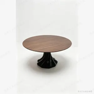 Lotus-Base Round Dining Table in Ash — in a room setting