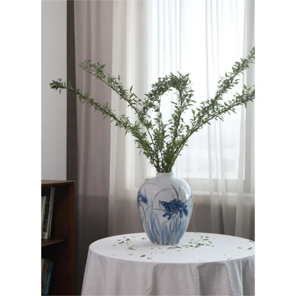 Hand-Painted Blue and White Mandarin Fish Jar in blue — in a room setting