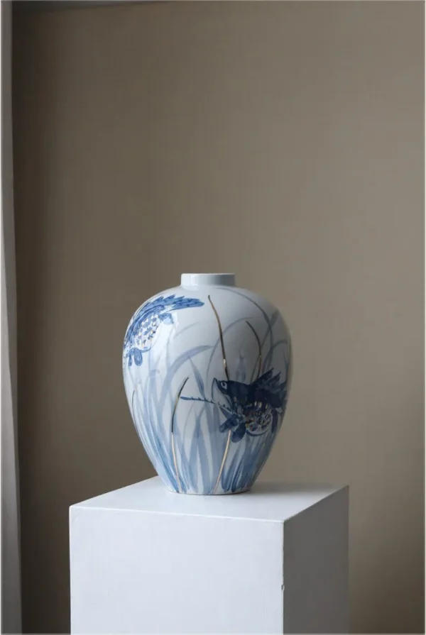 Hand-Painted Blue and White Mandarin Fish Jar in blue — in a room setting
