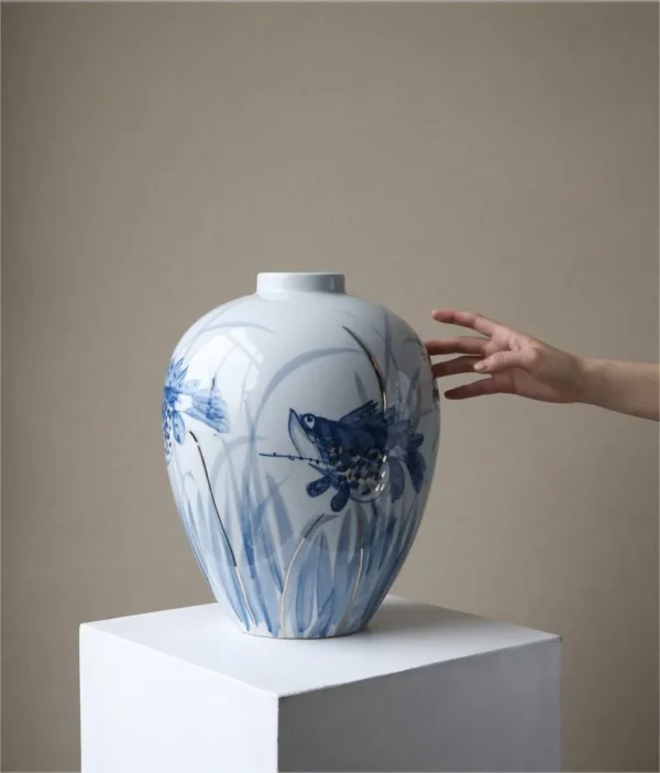 Hand-Painted Blue and White Mandarin Fish Jar in blue — in a room setting