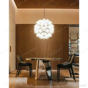 Mirror-Polished Steel Dining Table with Faceted Pedestals in silver — in a room setting