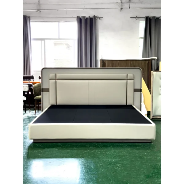 Cream Leather Bed with Sectioned Headboard and Metal Inlay in oatmeal — in a room setting