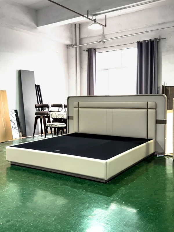 Cream Leather Bed with Sectioned Headboard and Metal Inlay in oatmeal — in a room setting