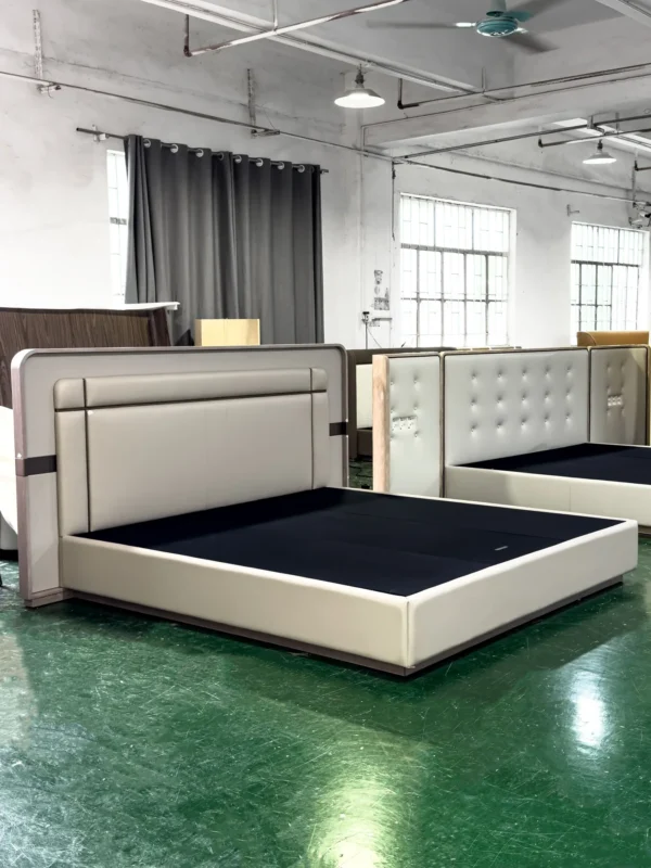 Cream Leather Bed with Sectioned Headboard and Metal Inlay in oatmeal — in a room setting