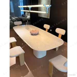 Rounded Rectangular Marble Dining Table on Pedestal Base in oatmeal — in a room setting