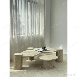 Organic Travertine Coffee Table with Cylinder Side Tables in sand — in a room setting