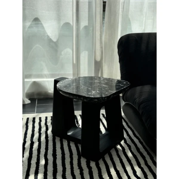 Black Marble Side Table on Black Geometric Wood Base in black — in a room setting