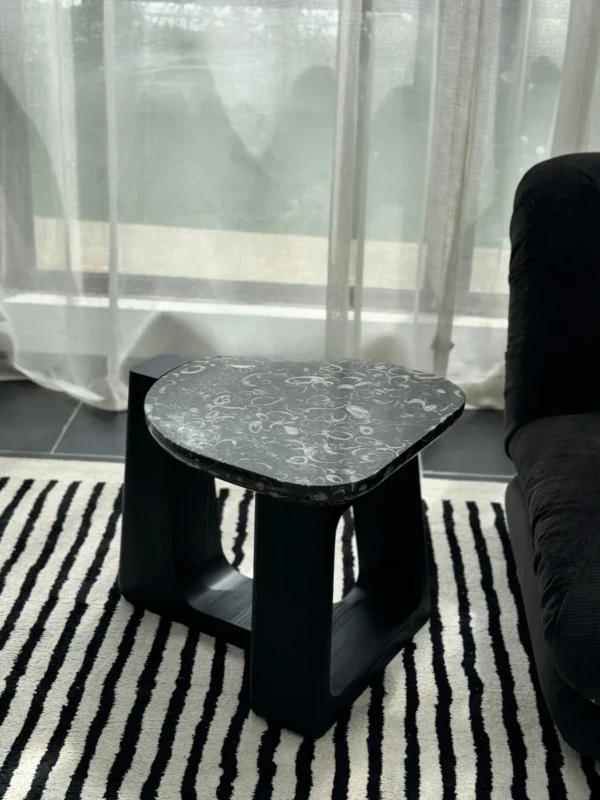 Black Marble Side Table on Black Geometric Wood Base in black — in a room setting