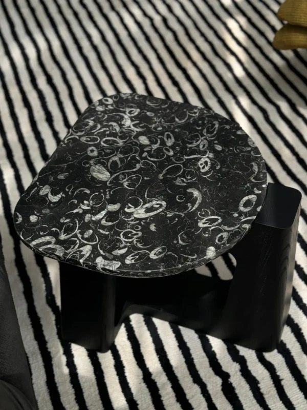 Black Marble Side Table on Black Geometric Wood Base in black — in a room setting