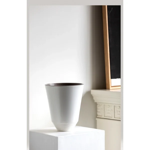 Matte White Cone Ceramic Vase with Spiral-Ribbed Base in ivory — in a room setting