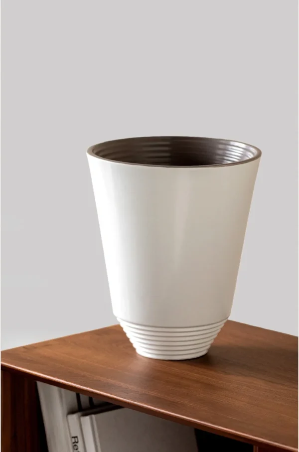 Matte White Cone Ceramic Vase with Spiral-Ribbed Base in ivory — in a room setting
