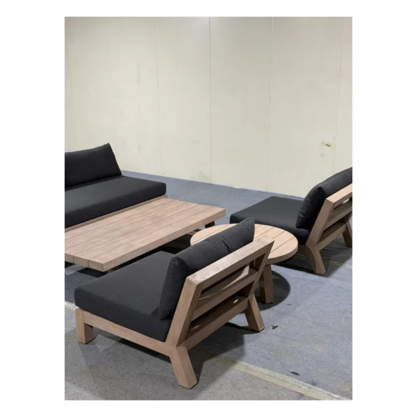 Solid Teak Outdoor Sofa Set with Navy Cushions in natural oak — in a room setting