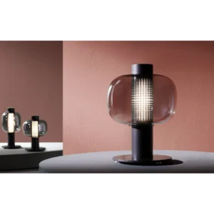 Smoked Glass Table Lamp with Perforated Black Column in black — in a room setting
