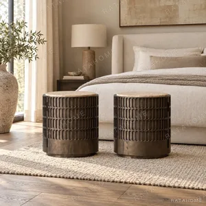Distressed Carved Drum Nightstand with Travertine Top in clay — in a room setting
