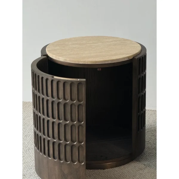 Distressed Carved Drum Nightstand with Travertine Top in clay — in a room setting