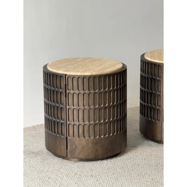 Distressed Carved Drum Nightstand with Travertine Top in clay — in a room setting