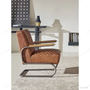 Rupert Quilted Tan Leather Cantilever Lounge Chair in clay — in a room setting