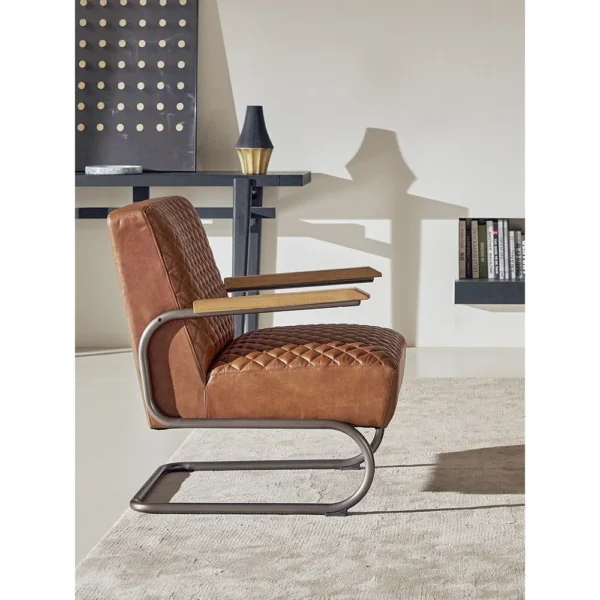 Rupert Quilted Tan Leather Cantilever Lounge Chair in clay — in a room setting