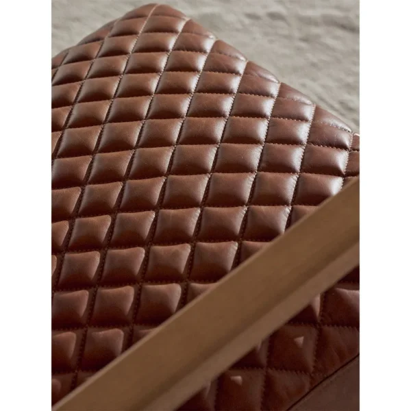 Rupert Quilted Tan Leather Cantilever Lounge Chair in clay — in a room setting