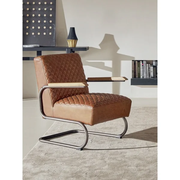 Rupert Quilted Tan Leather Cantilever Lounge Chair in clay — in a room setting