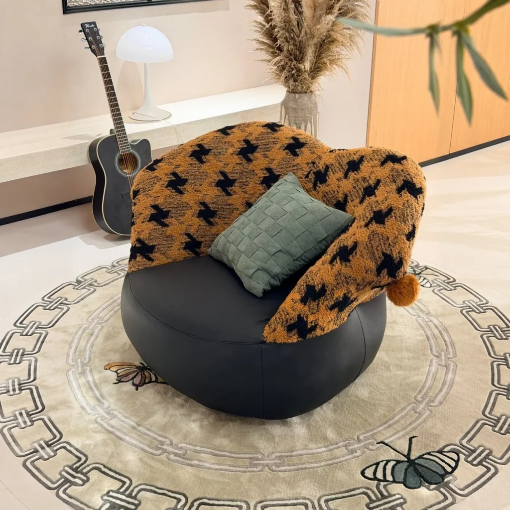 Mid-Century Houndstooth and Leather Round Lounge Chair in black — front view