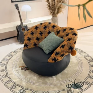 Mid-Century Houndstooth and Leather Round Lounge Chair in black — front view