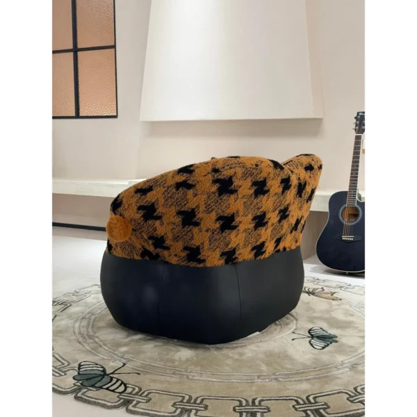 Mid-Century Houndstooth and Leather Round Lounge Chair in black — in a room setting