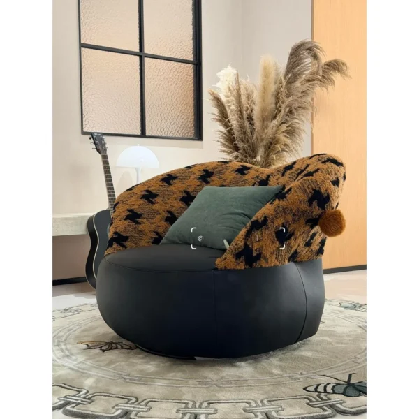 Mid-Century Houndstooth and Leather Round Lounge Chair in black — in a room setting