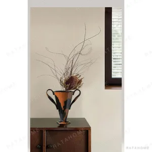 Twin-Handle Ceramic Amphora Vase in Orange and Black Glaze — in a room setting