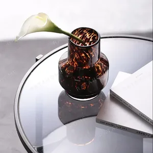 Tortoiseshell Glass Bud Vases, Large or Small in clay — in a room setting