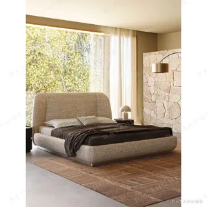 Curved Embrace Linen Bed on Floating Metal Base in sand — in a room setting