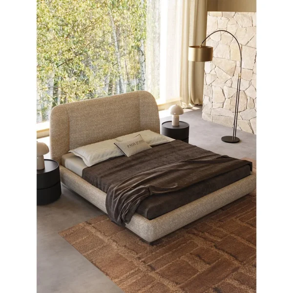 Curved Embrace Linen Bed on Floating Metal Base in sand — in a room setting