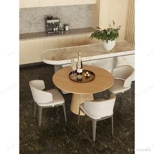 Round Oak Dining Table with Gilt-Detail Leather Chairs in natural oak — in a room setting