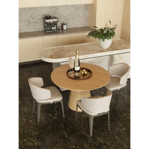 Round Oak Dining Table with Gilt-Detail Leather Chairs in natural oak — in a room setting