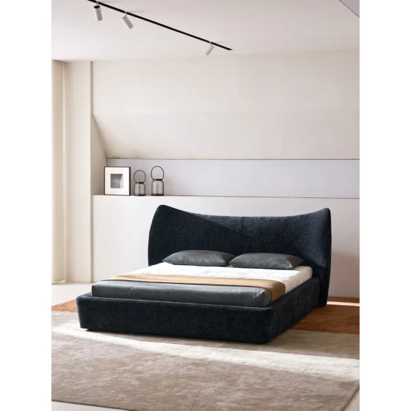 Fishtail Curved-Headboard Chenille Bed in black — in a room setting