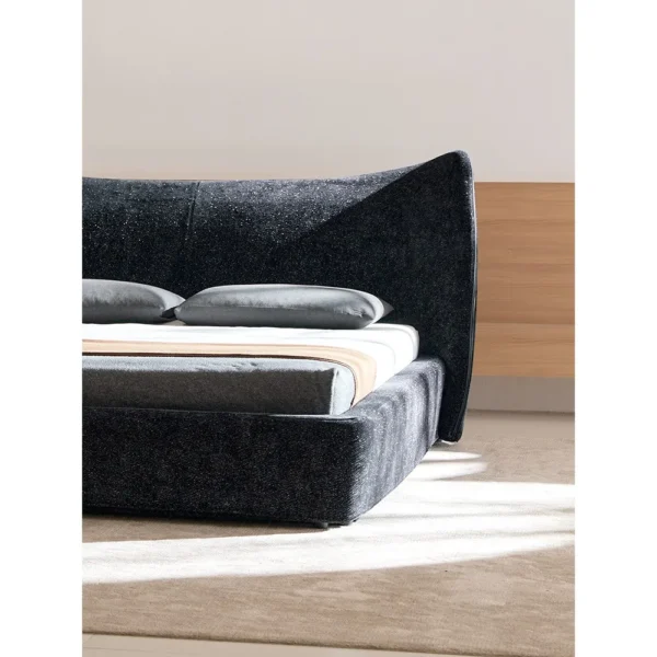 Fishtail Curved-Headboard Chenille Bed in black — in a room setting