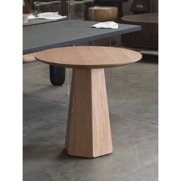 Minimalist Solid Wood Round Table on Faceted Cone in natural oak — in a room setting