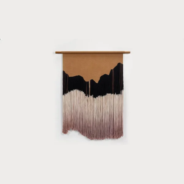 Fringed Fibre Wall Hanging in sand — in a room setting