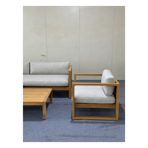 Teak Outdoor Sofa Set with Cream Quick-Dry Cushions in natural oak — in a room setting