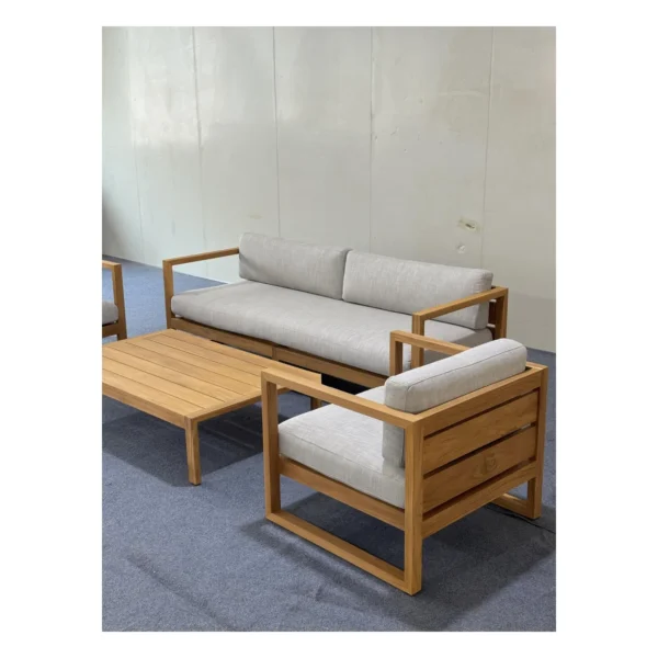 Teak Outdoor Sofa Set with Cream Quick-Dry Cushions in natural oak — in a room setting