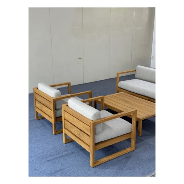 Teak Outdoor Sofa Set with Cream Quick-Dry Cushions in natural oak — in a room setting