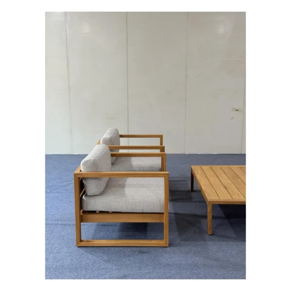Teak Outdoor Sofa Set with Cream Quick-Dry Cushions in natural oak — in a room setting