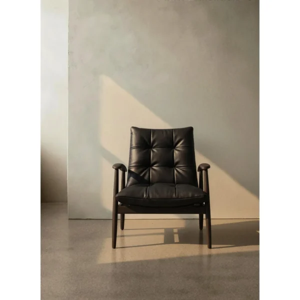 Brook Black Solid Wood Armchair with Tufted Leather Cushions in black — in a room setting
